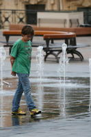 autumn, boy, casual, day, diffuse, diffused light, eye level view, fountain, Malta, natural light, walking