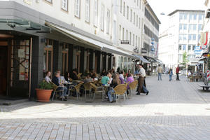 autumn, Bielefeld, bright, cafe, casual, chair, day, Deutschland, eye level view, furniture, Nordrhein-Westfalen, pavement, people, potted plant, sitting, street, sunny, waiter