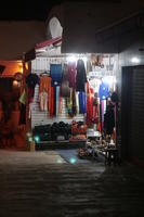 Agadir, artificial lighting, autumn, clothing, evening, eye level view, market, Morocco, object, souvenir, stall