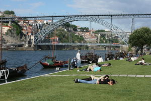 boat, bridge, casual, day, direct sunlight, eye level view, group, laying, people, Porto, Porto, Portugal, river, sitting, spring, sunbathing, sunny