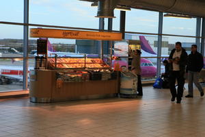 airport, artificial lighting, England, eye level view, food, group, hallway, kiosk, London, people, terminal, The United Kingdom, vendor, walking