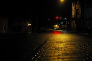 artificial lighting, city lights, eye level view, Kalisz, night, outdoor lighting, pavement, Poland, street, urban, wet, Wielkopolskie, winter