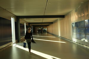 airport, Copenhagen , corridor, Denmark, dusk, eye level view, interior, Kobenhavn, spring, walking, woman