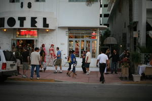 building, cafe, crowd, dusk, eye level view, Florida, hotel, mannequin, Miami, people, potted plant, retail, standing, street, summer, The United States, walking, winter