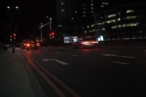 artificial lighting, building, cab, car, car lights, England, eye level view, London, night, spring, street, The United Kingdom, traffic, urban, walkway