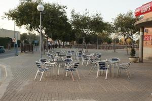 Alicante, cafe, chair, dusk, eye level view, furniture, Spain, table, tree, Valenciana, vegetation