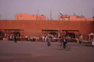 artificial lighting, autumn, cycling, dusk, eye level view, group, Marrakech, Marrakesh, middleastern, Morocco, people, square