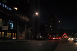 artificial lighting, car, city, city lights, England, eye level view, London, night, outdoor lighting, sign, street, The United Kingdom, urban