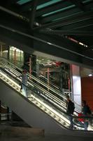 airport, artificial lighting, autumn, Barajas Airport, escalator, evening, eye level view, group, indoor lighting, interior, Madrid, people, Spain