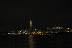 artificial lighting, city, cityscape, England, eye level view, London, night, river, riverbank, The United Kingdom