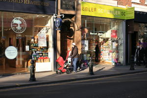 afternoon, day, England, eye level view, family, London, natural light, people, pushchair, retail, street, The United Kingdom, walking, winter, winter