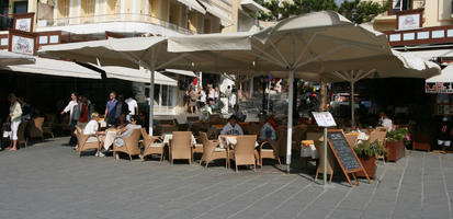 autumn, cafe, casual, Chania, day, eye level view, furniture, Greece, group, Iraklion (Crete), people, sitting, sunny, umbrella