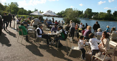 cafe, casual, chair, crowd, day, England, eye level view, furniture, London, park, people, sitting, summer, sunny, The United Kingdom, umbrella