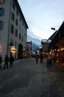 artificial lighting, evening, eye level view, France, group, people, Rhone-Alpes, road, snow, village, winter