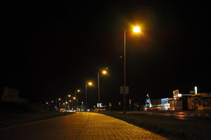 artificial lighting, city lights, eye level view, Kalisz, night, outdoor lighting, pavement, Poland, street, urban, wet, Wielkopolskie, winter