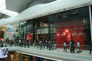 day, England, eye level view, group, indoor lighting, interior, London, mall, natural light, people, retail, shop, shopping, shopping centre, The United Kingdom, walking