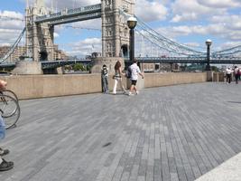 couple, day, England, eye level view, group, London, pavement, people, sunny, The United Kingdom