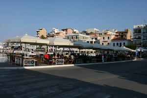 Agios Nikolaos, architecture, autumn, balustrade, cafe, casual, chair, day, eye level view, furniture, Greece, group, Lasithi, object, parasol, people, sitting, street, summer, table