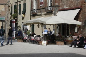 cafe, casual, day, eye level view, furniture, group, people, sitting, spring, standing, street, sunny, umbrella