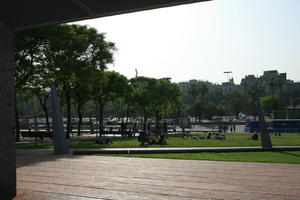 Barcelona, Cataluña, day, eye level view, family, group, park, people, sitting, Spain, sunbathing, sunny, tree, vegetation