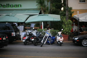 cafe, canopy, dusk, eye level view, Florida, Miami, motorcycle, potted plant, street, The United States, transport, winter