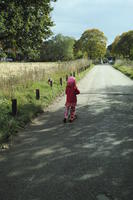 autumn, bright, child, day, England, eye level view, grass, London, park, riding, road, The United Kingdom, vegetation