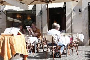 chair, day, eye level view, furniture, Italia , Lazio, people, restaurant, Rome, sitting, street, summer, sunny, table, umbrella