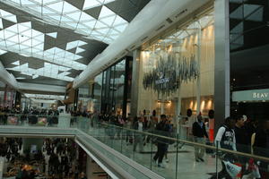 day, England, eye level view, group, indoor lighting, interior, London, mall, natural light, people, retail, shop, shopping, shopping centre, The United Kingdom, walking