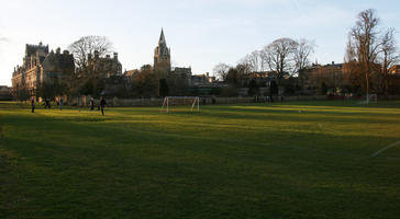 bright, building, dusk, England, eye level view, football pitch, grass, group, Oxford, park, people, sport, The United Kingdom, vegetation, winter