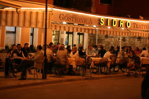 artificial lighting, cafe, chair, Croatia, eye level view, furniture, group, Istarska, night, object, people, restaurant, sign, sitting, spring, street, table